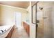 This main bathroom has a walk-in shower, double sink vanity, and a large soaking tub for the ultimate relaxation at 80 Shambley Meadows Dr, Pittsboro, NC 27312