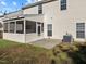 View of the back exterior with a screen porch and lawn at 821 Stackhurst Way, Wake Forest, NC 27587