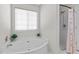 Bathroom featuring a relaxing tub, a separate shower, and natural light from a window at 821 Stackhurst Way, Wake Forest, NC 27587