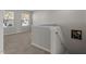 Bright hallway with neutral carpet leading to staircase and offering natural light from two windows at 821 Stackhurst Way, Wake Forest, NC 27587