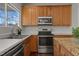 Kitchen showing stainless steel oven and sink, bathed in natural light from the large window at 821 Stackhurst Way, Wake Forest, NC 27587