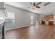 Open concept living room with hardwood floors leading to the kitchen, offering ample natural light at 821 Stackhurst Way, Wake Forest, NC 27587