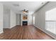 Expansive living area with hardwood floors, a fireplace, and large windows offering a comfortable living space at 821 Stackhurst Way, Wake Forest, NC 27587
