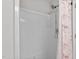 Modern shower featuring white tile, a convenient handheld shower head, and decorative shower curtain at 821 Stackhurst Way, Wake Forest, NC 27587