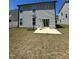 Backyard with a basketball hoop, sliding glass door and grass at 99 Still Hand Dr, Clayton, NC 27527