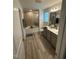 Bathroom featuring a double sink vanity and tiled shower with glass doors at 99 Still Hand Dr, Clayton, NC 27527