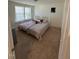 Cozy bedroom featuring plush carpeting, a comfortable bed, and soft, natural light at 99 Still Hand Dr, Clayton, NC 27527