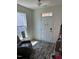 Welcoming entryway with coat hooks, an entry bench, and natural light from the sidelight window at 99 Still Hand Dr, Clayton, NC 27527
