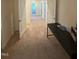 Hallway featuring plush carpet, multiple doorways and a convenient desk area at 99 Still Hand Dr, Clayton, NC 27527