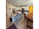 Open concept kitchen with large island, stainless appliances and adjacent dining area at 99 Still Hand Dr, Clayton, NC 27527