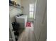 Well-lit laundry room with a washer/dryer, shelving, and vinyl floors at 99 Still Hand Dr, Clayton, NC 27527