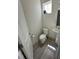 Clean powder room with a white pedestal sink, toilet, and wood-look vinyl floors at 99 Still Hand Dr, Clayton, NC 27527