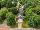 Aerial view of the property showcasing its manicured lawn, mature trees, and prime location within the neighborhood at 100 Silver Lining Ln, Cary, NC 27513