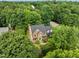 Gorgeous brick home features classic shutters, pristine landscaping, and is nestled in a tree-filled community at 100 Silver Lining Ln, Cary, NC 27513