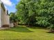 Landscaped backyard with mature trees and stairs leading to deck at 100 Silver Lining Ln, Cary, NC 27513