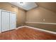 Bedroom with gleaming hardwood floors, closet, and neutral paint at 100 Silver Lining Ln, Cary, NC 27513