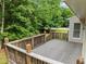 Private deck with wooden railings, offering a cozy outdoor space with views of the surrounding trees at 100 Silver Lining Ln, Cary, NC 27513