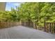 Inviting wooden deck surrounded by lush greenery offers a serene outdoor space to relax and enjoy the natural surroundings at 100 Silver Lining Ln, Cary, NC 27513