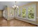 Dining room with hardwood floors, chandelier and many windows at 100 Silver Lining Ln, Cary, NC 27513