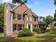 Traditional brick home with black shutters and front yard with green grass at 100 Silver Lining Ln, Cary, NC 27513
