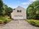 Home's exterior with a clean garage, driveway, and lush landscaping, offering great curb appeal at 100 Silver Lining Ln, Cary, NC 27513
