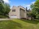 Back of home featuring attached garage, back yard, and wooden deck at 100 Silver Lining Ln, Cary, NC 27513