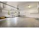 Spacious garage featuring white cabinets and work benches at 100 Silver Lining Ln, Cary, NC 27513
