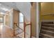 Hallway with hardwood floors, natural light, and staircase leading to the upper level of the home at 100 Silver Lining Ln, Cary, NC 27513