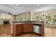 Open kitchen layout with granite countertops and stainless steel dishwasher in a sunlit room at 100 Silver Lining Ln, Cary, NC 27513