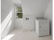 Bright laundry area with tile floor and includes a washing machine and dryer at 100 Silver Lining Ln, Cary, NC 27513