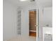 Laundry room with sink and shelving for organized storage and convenience at 100 Silver Lining Ln, Cary, NC 27513