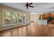 Open-concept living room with fireplace, hardwood floors, many windows, and access to the dining area and kitchen at 100 Silver Lining Ln, Cary, NC 27513
