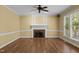 Living room featuring hardwood floors, a fireplace, and large windows at 100 Silver Lining Ln, Cary, NC 27513