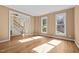 Sun-filled living room with hardwood floors and large windows with views of the outdoors at 100 Silver Lining Ln, Cary, NC 27513