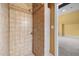 Tile shower featuring tile surround, shower head, and built in shelving at 100 Silver Lining Ln, Cary, NC 27513