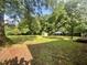 This backyard features mature trees and a storage shed at 1012 Bermuda Run, Knightdale, NC 27545