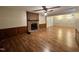 Spacious living room featuring a brick fireplace and wood floors, perfect for gatherings at 1012 Bermuda Run, Knightdale, NC 27545