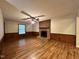 Comfortable living room featuring a cozy brick fireplace and ceiling fan at 1012 Bermuda Run, Knightdale, NC 27545
