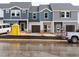 New townhomes with attached garages are under construction, featuring mixed siding and dark grey roofs at 1031 Winding Spring Dr, Mebane, NC 27302