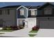 Charming two-story townhome boasts stylish blue siding, a one-car garage, and manicured landscaping at 1031 Winding Spring Dr, Mebane, NC 27302