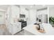 Modern kitchen featuring white cabinetry, stainless steel appliances, and island with breakfast bar seating at 1031 Winding Spring Dr, Mebane, NC 27302