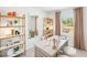 Bright office space with light wood desk, open shelving, and neutral decor at 1031 Winding Spring Dr, Mebane, NC 27302