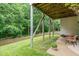 The backyard features a covered area with chairs, a small table, and a view of the lush landscaping at 104 Edgewater Cir, Chapel Hill, NC 27516