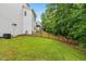 Spacious backyard featuring green grass and partial fencing for privacy at 104 Edgewater Cir, Chapel Hill, NC 27516