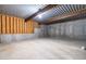 Unfinished basement with exposed concrete walls and open ceiling, ready for customization at 104 Edgewater Cir, Chapel Hill, NC 27516