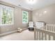 Cozy bedroom designed with windows bringing in plenty of natural light at 104 Edgewater Cir, Chapel Hill, NC 27516