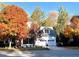 Charming two-story home with a dormer window, two car garage, and vibrant autumn foliage at 104 Edgewater Cir, Chapel Hill, NC 27516