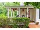 Charming front porch with hanging flower baskets and egg chairs welcomes you home at 104 Edgewater Cir, Chapel Hill, NC 27516