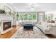 Bright and airy living room with a fireplace, large windows, and hardwood floors at 104 Edgewater Cir, Chapel Hill, NC 27516