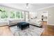 Bright living room with large windows, comfortable sofas, and an open floor plan at 104 Edgewater Cir, Chapel Hill, NC 27516